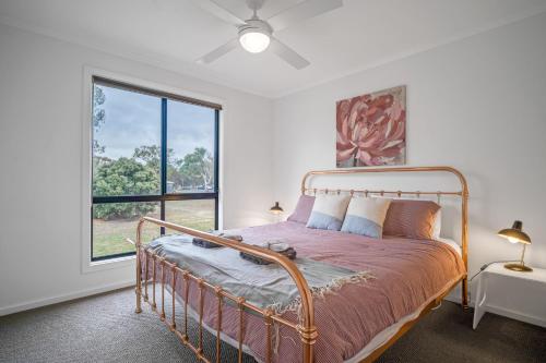 a bedroom with a bed and a large window at Long Island Retreat - Rosella in Murray Bridge
