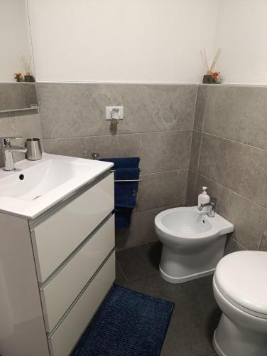 a bathroom with a white sink and a toilet at Su Planu in Cagliari