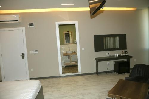 a bedroom with a bed and a desk and a mirror at Zoom Airport Hotels in Istanbul