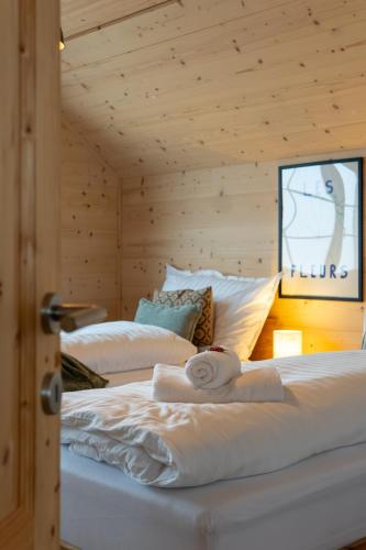 a bedroom with two beds in a log cabin at Ganzes Haus am Bodensee in den Bergen im Appenzell in Heiden