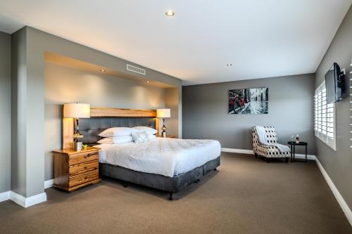 a bedroom with a large bed and a chair at Il Mare' in Albany