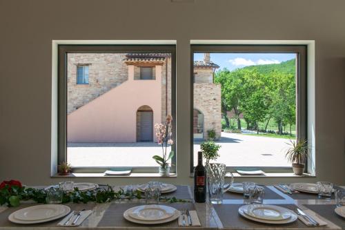 a table with a view of a building through a window at Agriturismo Colle Casini Cortesi in Caldarola