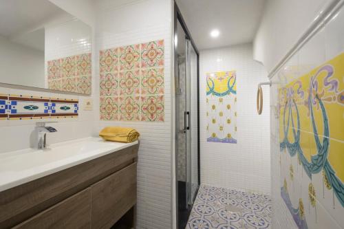 a bathroom with a sink and a shower at The Tile House in Güéjar-Sierra