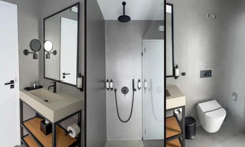 a bathroom with a shower and a sink and a toilet at Mar Puro in Ericeira