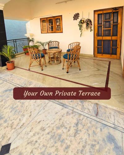 a sign on a patio with chairs and a table at Ashiana By Ijabojyu- Pet friendly Homestay in Dehradun
