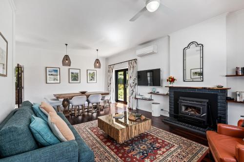 a living room with a blue couch and a fireplace at Esto house in Crafers