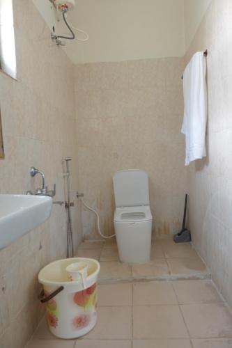 a bathroom with a toilet and a sink at Thiruveesar Family Retreat near Airport in Tiruchirappalli