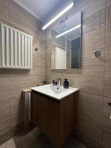 a bathroom with a sink and a mirror at KONAR Guest House in Alexandroupoli