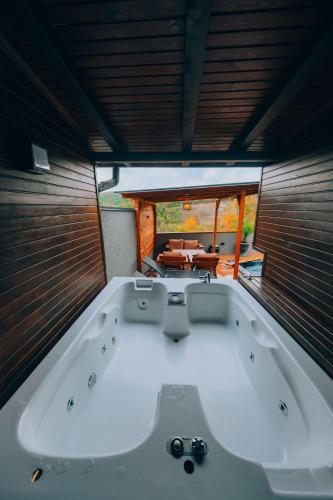 a large white bath tub in a room with a table at Sapanca Ruby Bungalow in Sapanca