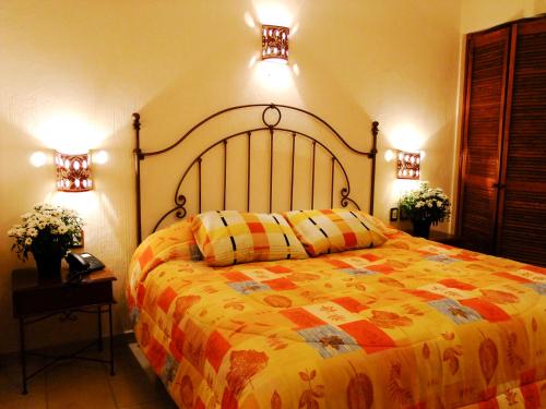 sypialnia z dużym łóżkiem i 2 światłami w obiekcie Hotel Dainzu w mieście Oaxaca
