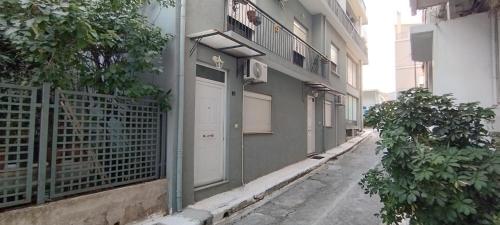 a building with a white door and a balcony at Διατίθεται Γκαρσονιέρα in Kalamata