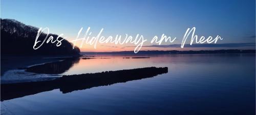 a sign that says happiness is an river at sunset at Strandhygge in Flensburg