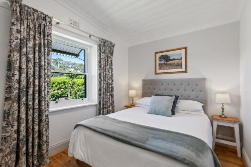 a bedroom with a bed and a window at The Other House in Piccadilly
