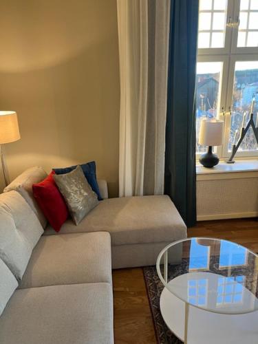 a living room with a couch and a glass table at Villa Thurdus in Härnösand