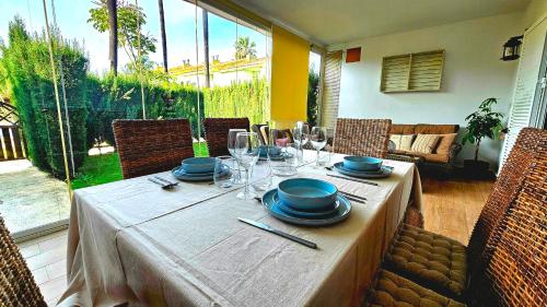 a table with plates and wine glasses on it at Pura Vida in Lepe