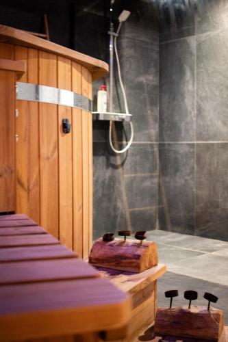 a bathroom with a shower and two stools at Suite Nordique - Cinéma et Jacuzzi in Bordeaux