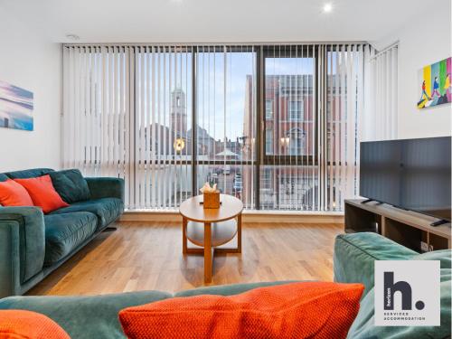 a living room with a couch and a table at Contractors - Long Stay - City Centre - Free Parking - Balcony in Hull