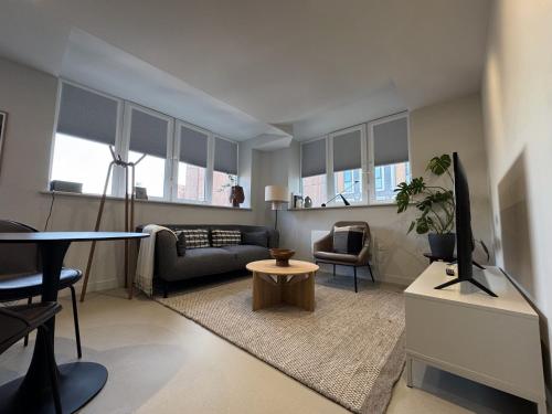 a living room with a couch and a table at LIVINGWAY Roco in Liverpool