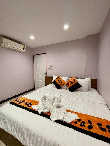 a bedroom with a bed with towels on it at Sampheng Apartment in Bangkok