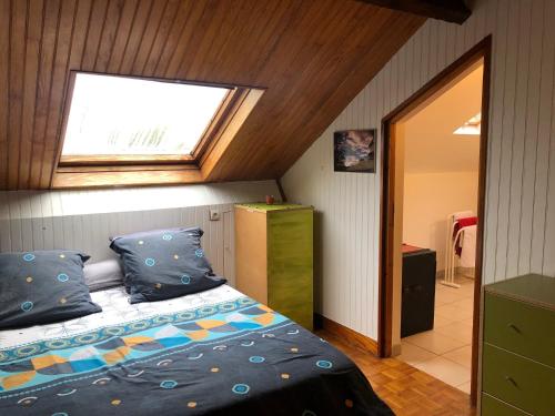 a bedroom with a bed and a skylight at Chelles - Paris - Disneyland Marne la vallée in Chelles