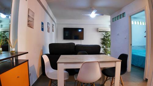 a living room with a dining room table and chairs at Apartalux Vera Rincón de Loix in Benidorm
