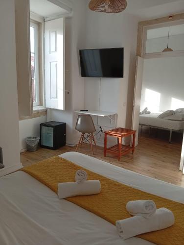 a bedroom with a bed with two towels on it at Casa João Chagas Guesthouse, Constância, By Viva a Vida - Alojamentos e Hotels in Constância