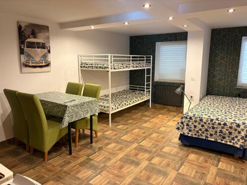a room with two beds and a table and a bunk bed at Agrobiskupin Kaczmarek 2 in Gąsawa