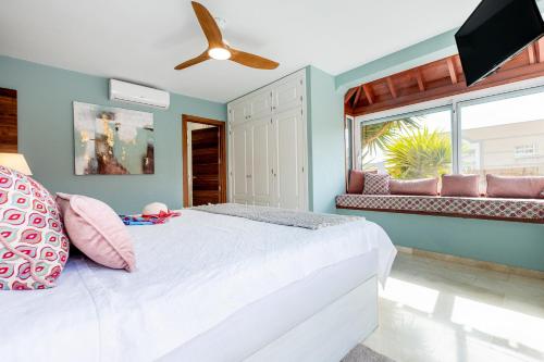 a bedroom with a white bed and a ceiling fan at Villa Cornelia in Adeje
