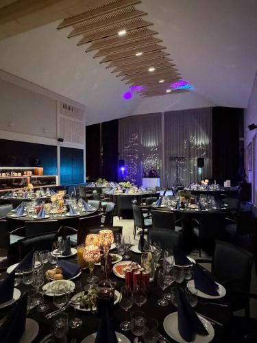 a dining room filled with tables with plates of food at Royal Horse Resort in Balkasodis
