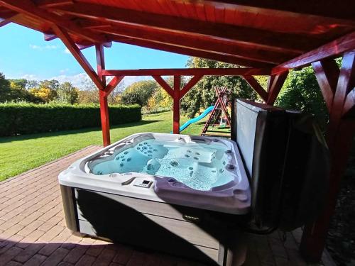 a hot tub sitting under a gazebo at Chalupa Trosenka in Troskovice