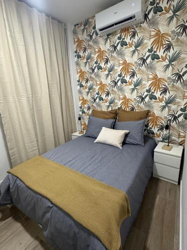 a bedroom with a bed with a wall mural at La Casa de Mara in Madrid