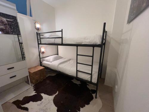 a bedroom with two bunk beds in a room at Shoreline Apartment Katwijk in Katwijk aan Zee