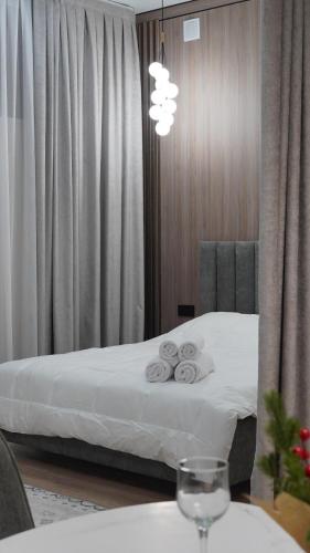 a hotel room with a bed with two towels at Zhaily Hotel in Semey