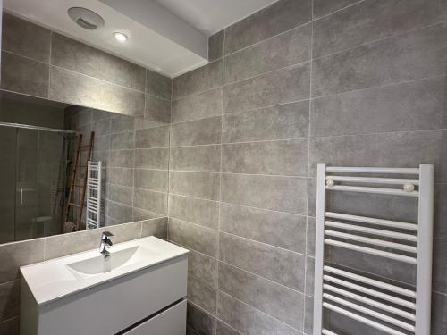 a bathroom with a sink and a mirror at Résidence Le Vénusia - 2 in Port-Vendres
