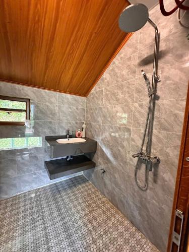a bathroom with a sink and a shower at Homestay field - bungalow, Ha giang loop tour, motorbikes rental in Ha Giang
