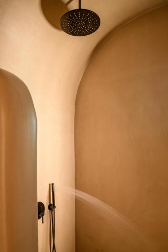 a room with a ceiling with a light fixture at Secret Path Luxury Villas in Imerovigli