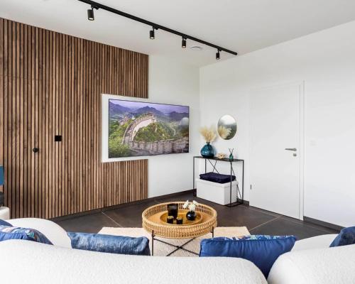 a living room with a couch and a table at Nomad Village in Verviers