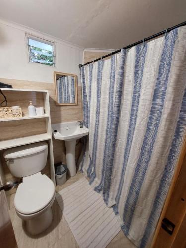 a bathroom with a toilet and a sink at Aldea Bahiguana in Bahia Inglesa