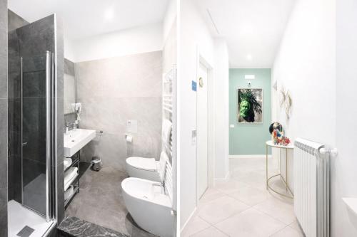 a bathroom with a toilet and a sink at Maqueda Suites in Palermo