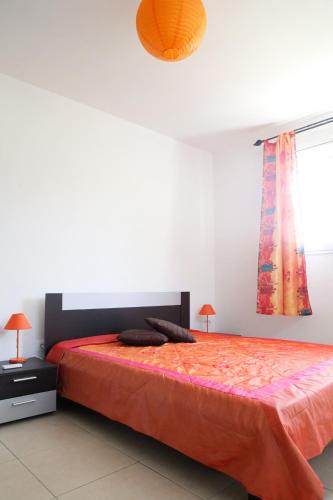 a bedroom with a large bed and a window at Kaïvivi in Le Marin