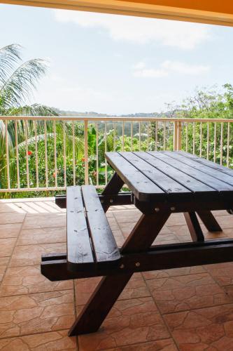 a wooden picnic table sitting on top of a balcony at Kaïvivi in Le Marin