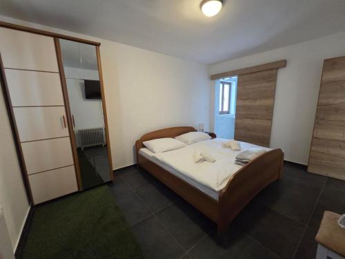 a bedroom with a bed and a large mirror at Villa Roko - Gacka Valley in Ličko Lešće