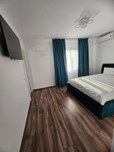 a bedroom with a bed and a flat screen tv at Luxury LCF in Brăila