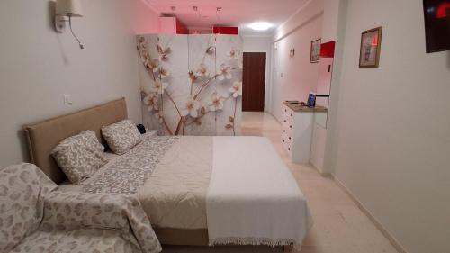 a bedroom with a bed and a couch in it at Modern Studio by the sea in Loutra Edipsou