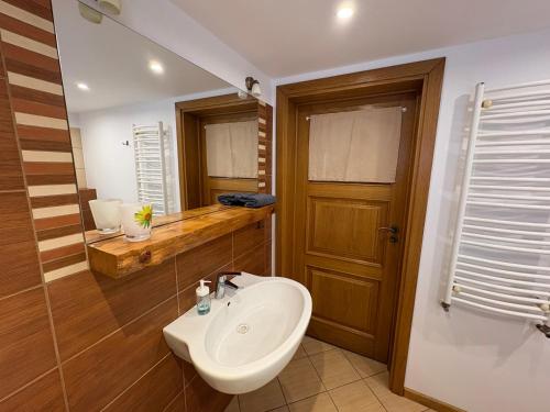 a bathroom with a white sink and a toilet at Plażowa Przytulny Dom Na Wyłączność in Białystok