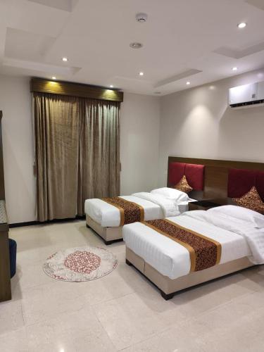 three beds in a hotel room with at شقق همسات المخدومة in Khamis Mushayt
