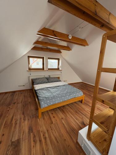 a bedroom with a bed and a ladder at Plażowa Przytulny Dom Na Wyłączność in Białystok