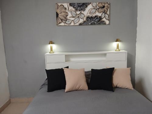 a bed with two lamps on top of it at Merlo mar 2 in Merlo