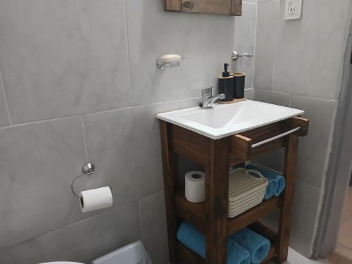 a bathroom with a sink and a toilet at Merlo mar 2 in Merlo