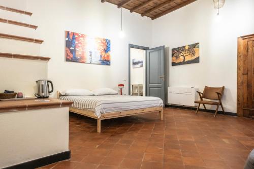 a bedroom with a bed and a table and a chair at Affittacamere Bernardo Ricci in Albenga